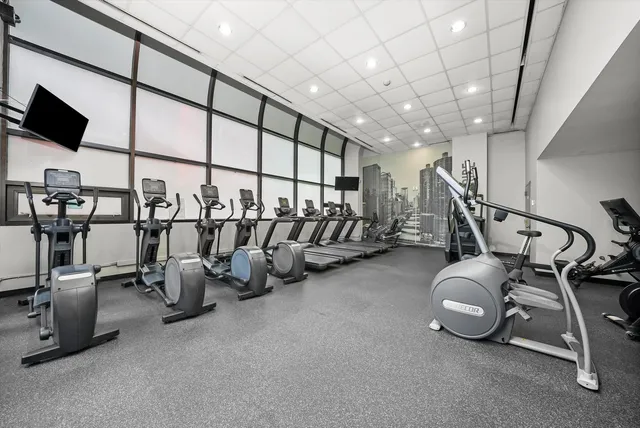 a view of roof deck with wooden floor and seating space