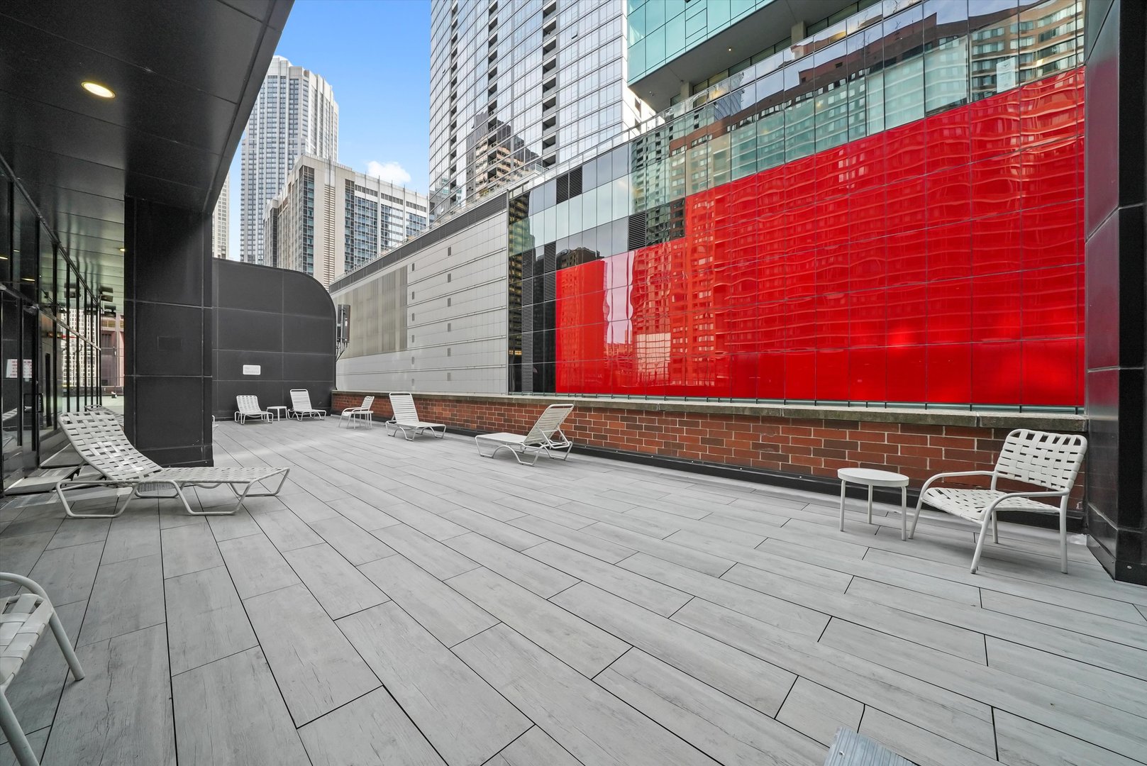 211 East Ohio Street, Unit 2707 Chicago, IL 60611 - Photo 38 of 45 a view of roof deck with wooden floor and seating space