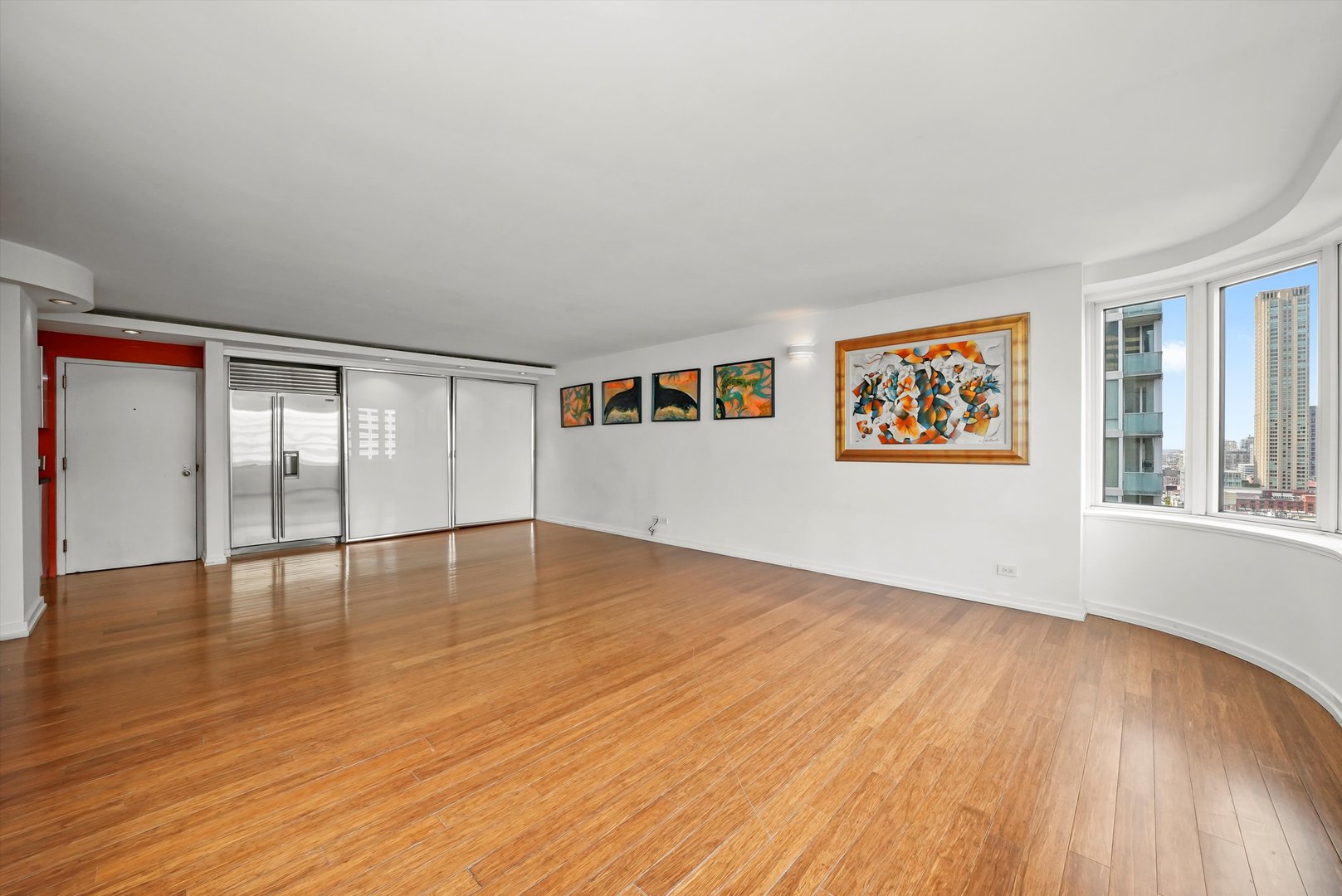 211 East Ohio Street, Unit 2707 Chicago, IL 60611 - Photo 8 of 45 wooden floor in an empty room with a window