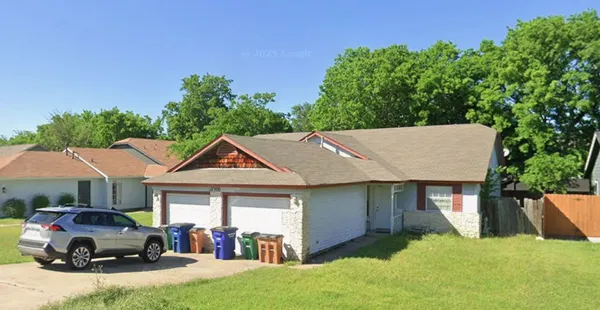 a front view of a house with a yard table and chairs