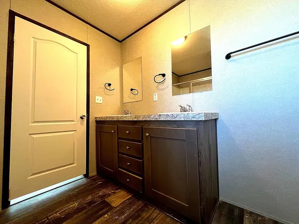 a bedroom with a bed and a mirror