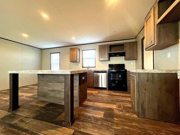 a room with a sink wooden floor and furniture