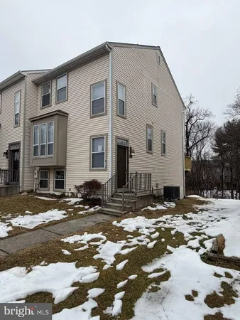 a view of a house with a snow on the side of a street