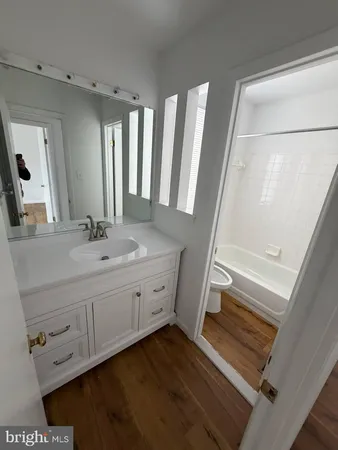 a bathroom with 2 sink tub and a mirror