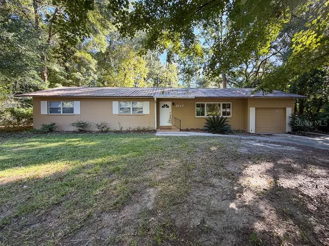 a view of a house with yard and a tree