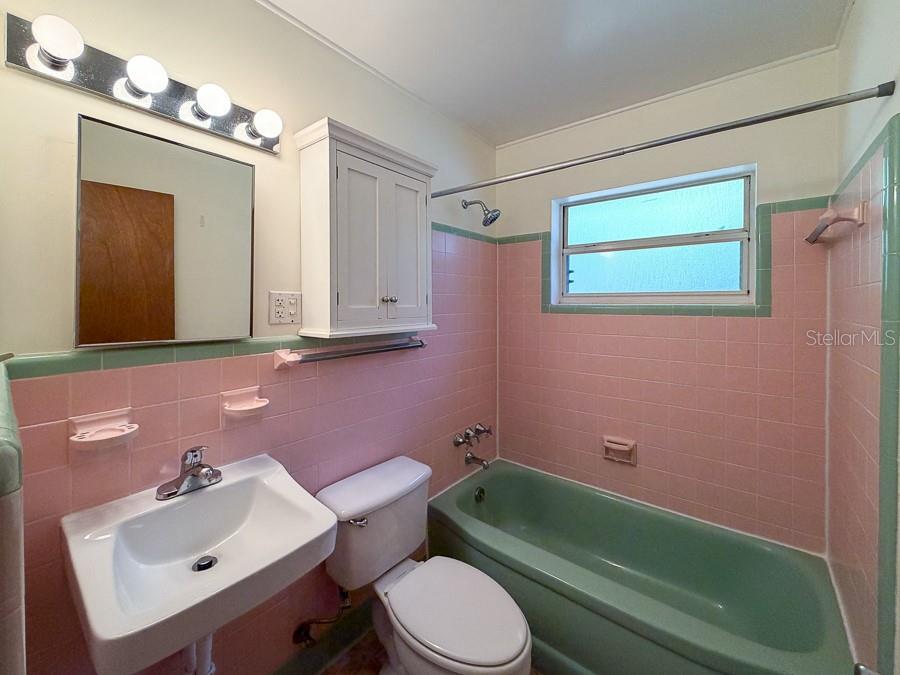 3027 Northwest 1st Avenue Gainesville, FL 32607 - Photo 14 of 31 a bathroom with a toilet sink and mirror