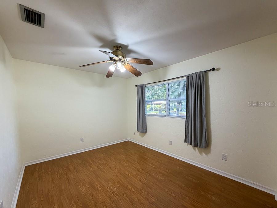 3027 Northwest 1st Avenue Gainesville, FL 32607 - Photo 15 of 31 an empty room with wooden floor and windows