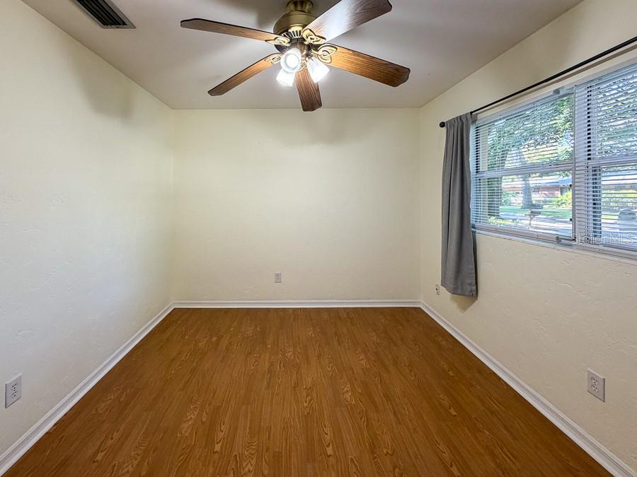 3027 Northwest 1st Avenue Gainesville, FL 32607 - Photo 16 of 31 wooden floor in an empty room with a window