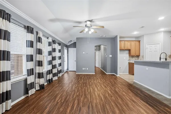 a view of a kitchen with wooden floor and a kitchen