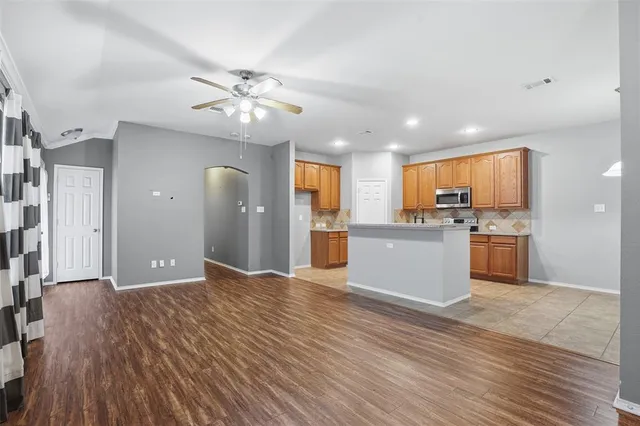 a kitchen with stainless steel appliances granite countertop a sink and stove top oven