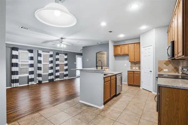 a kitchen with stainless steel appliances granite countertop a sink and stove top oven