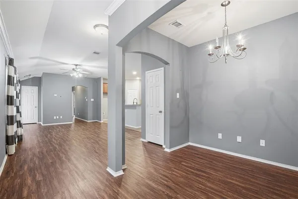 a view of a chandelier fan and wooden floor