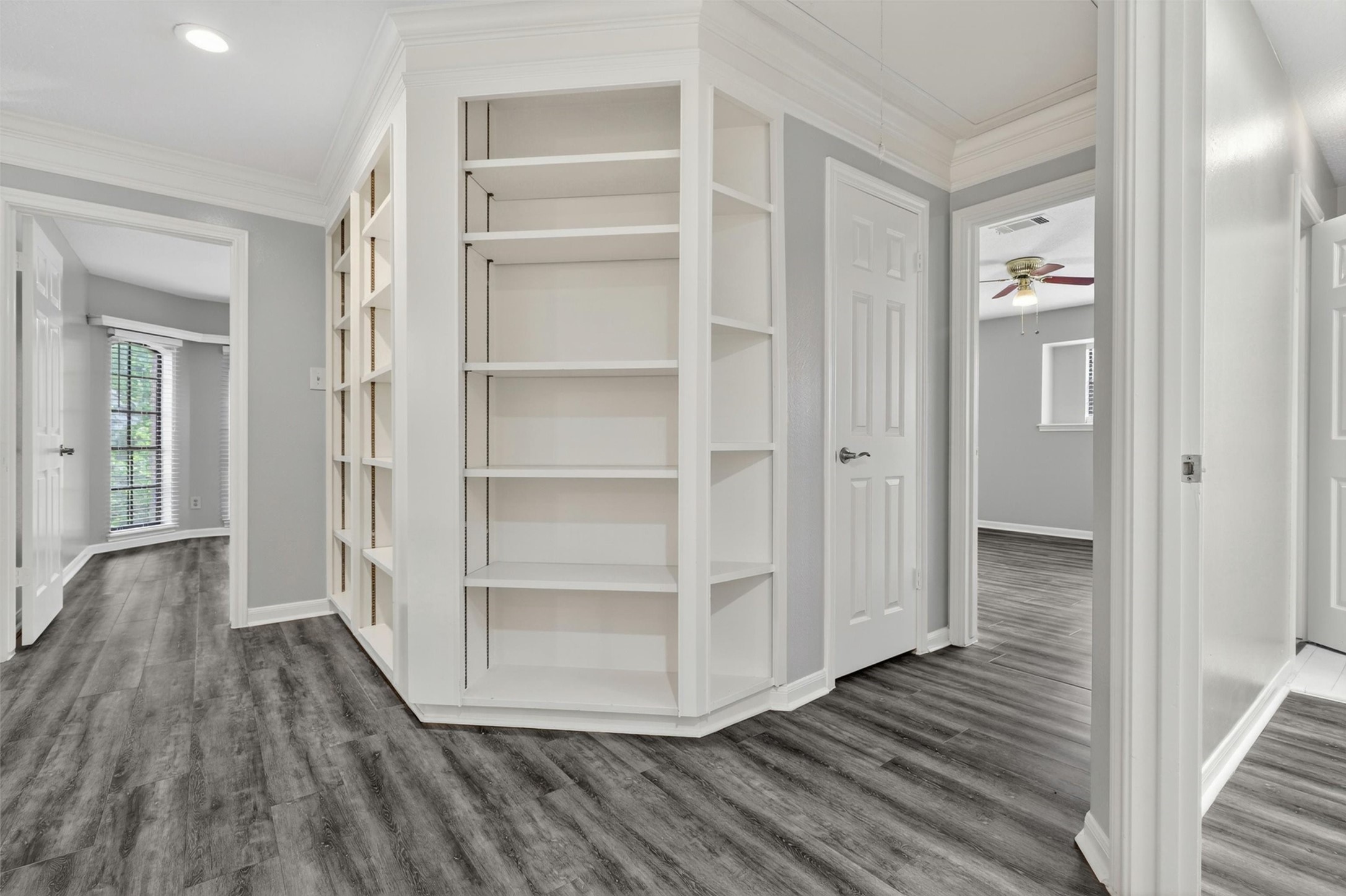 12929 Kingsbridge Lane Houston, TX 77077 - Photo 27 of 42 The second floor features stunning custom built-in shelving that adds both character and functionality to the home. Perfect for a private library, home office, study area, or decorative display space, this unique architectural feature creates a sophisticated and upscale feel buyers will love. The open hallway design, elegant trim work, and modern flooring enhance the bright and airy atmosphere throughout the upper level.