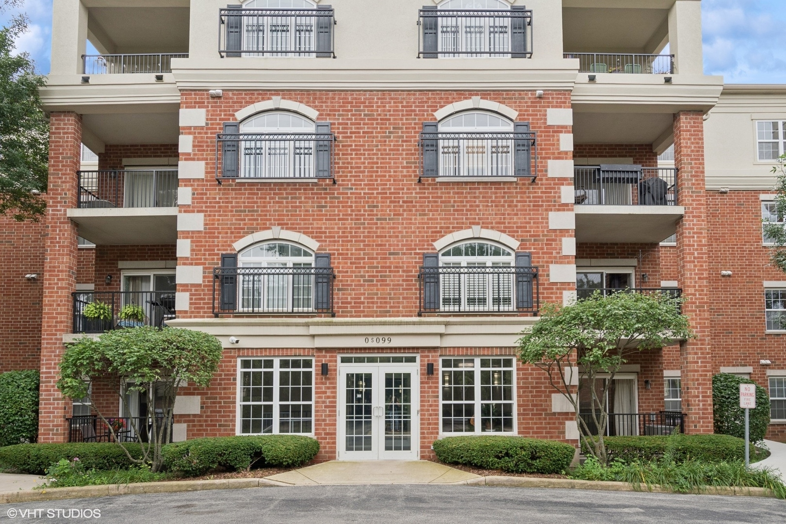 -s099 Lee Court, Unit 401 Winfield, IL 60190 - Photo 1 of 19 front view of brick building