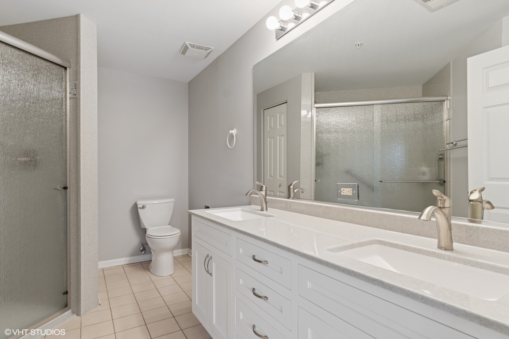 -s099 Lee Court, Unit 401 Winfield, IL 60190 - Photo 11 of 19 a bathroom with a sink a toilet and a mirror
