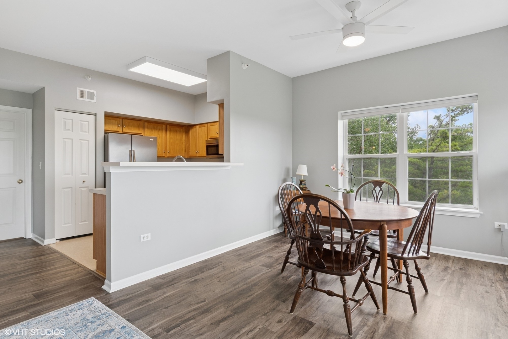 -s099 Lee Court, Unit 401 Winfield, IL 60190 - Photo 4 of 19 a view of a dining room with furniture window and wooden floor
