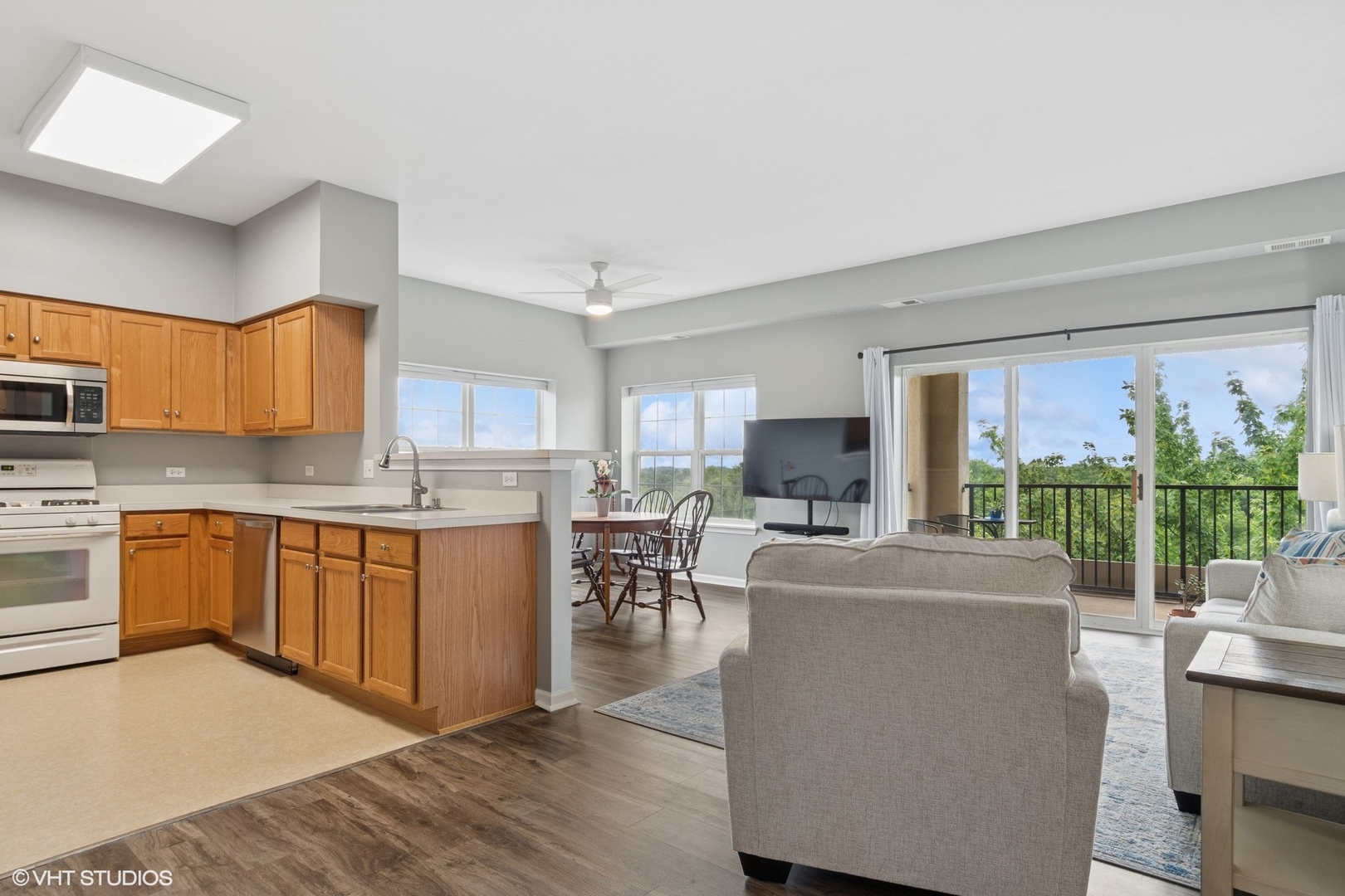 -s099 Lee Court, Unit 401 Winfield, IL 60190 - Photo 8 of 19 a large open kitchen with granite countertop a stove a sink a dining table and chairs