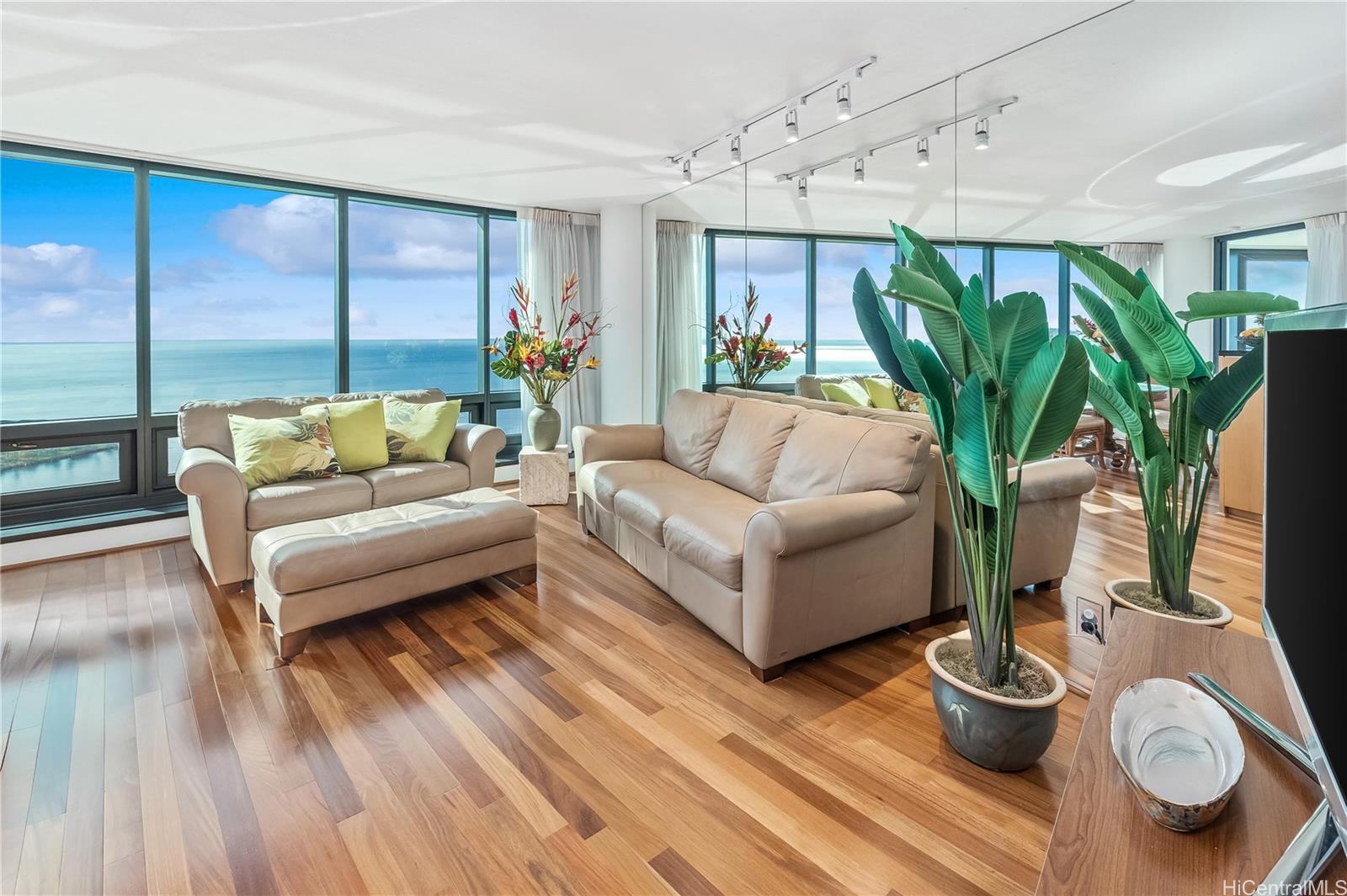 a living room with furniture and a potted plant