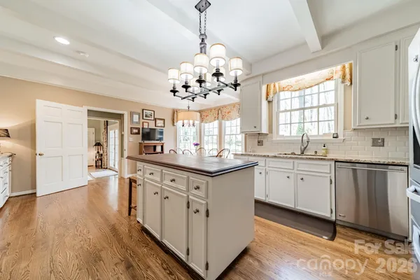 a kitchen with stainless steel appliances granite countertop a stove and a sink