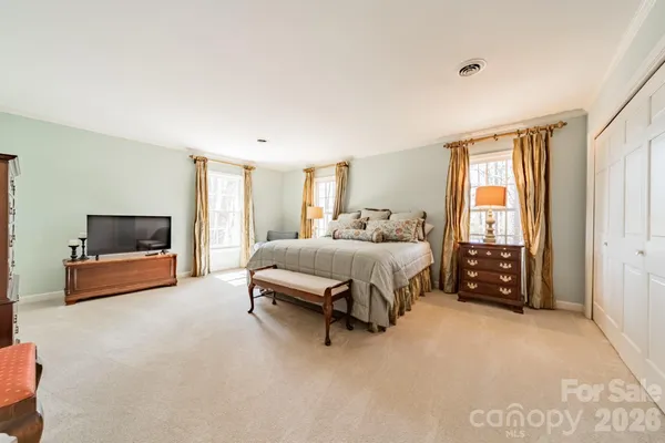 a bedroom with a bed and a couch