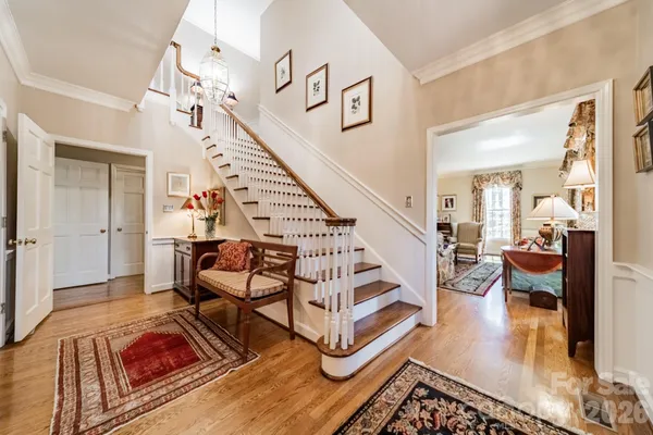 a living room with lots of furniture and stairs