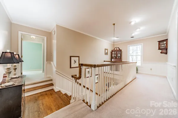 a view of a hallway with stairs