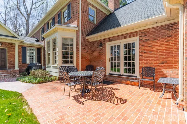 a view of a patio with table and chairs and wooden fence