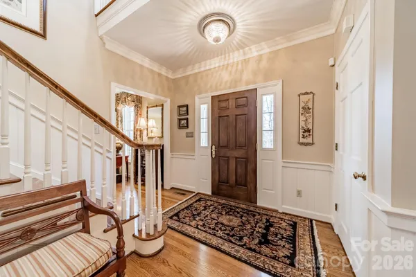 a view of entryway with a rug wooden floor and a rug