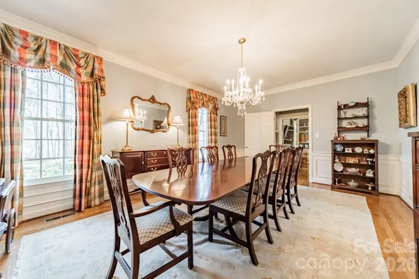 a view of a dining room with furniture and chandelier