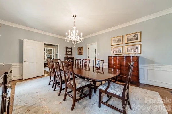 a view of a dining room with furniture and chandelier
