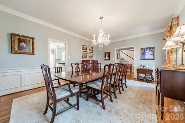 a view of a dining room with furniture and chandelier