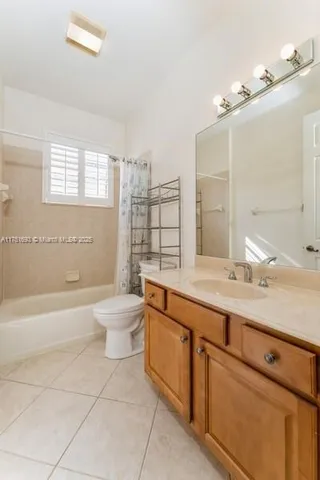 a bathroom with a granite countertop toilet a sink and bathtub