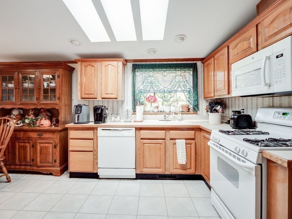 17 Medallion Road Holbrook, MA 02343 - Photo 13 of 39 a kitchen with stainless steel appliances granite countertop a stove a sink and a refrigerator