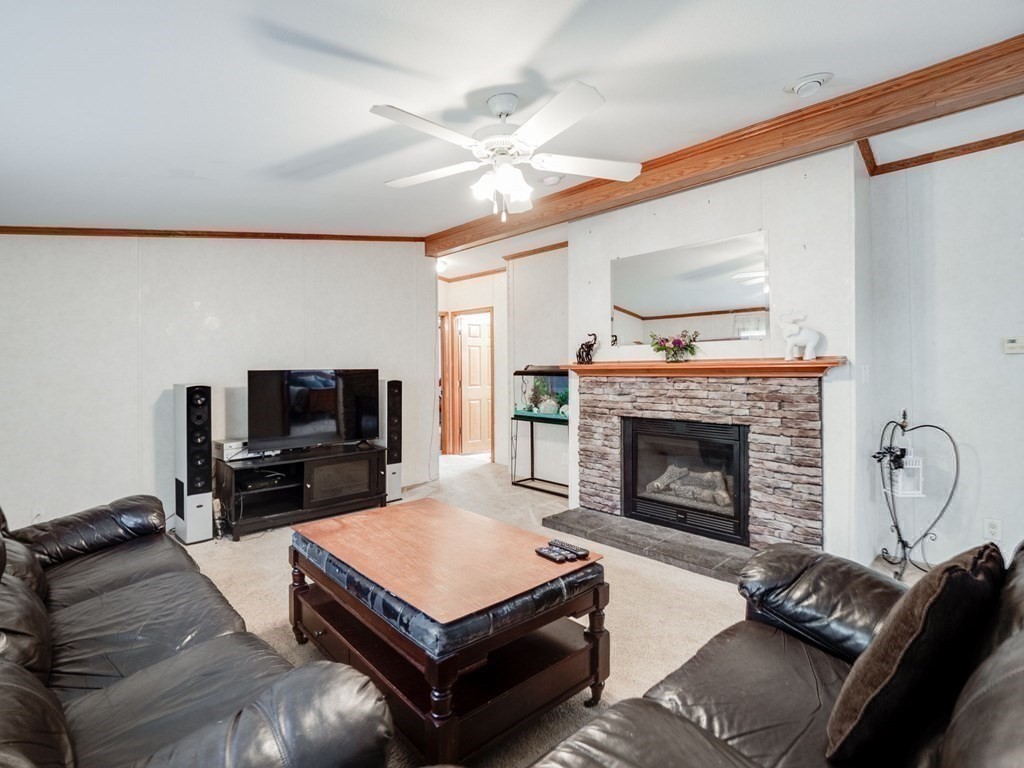 17 Medallion Road Holbrook, MA 02343 - Photo 15 of 39 a living room with furniture a flat screen tv and a fireplace
