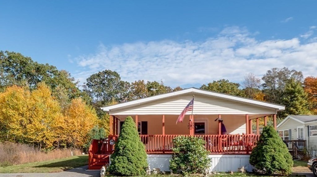 17 Medallion Road Holbrook, MA 02343 - Photo 2 of 39 a view of a white house next to a yard with plants and trees