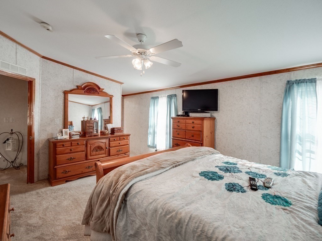 17 Medallion Road Holbrook, MA 02343 - Photo 21 of 39 a bedroom with a large bed a flat tv screen and dresser