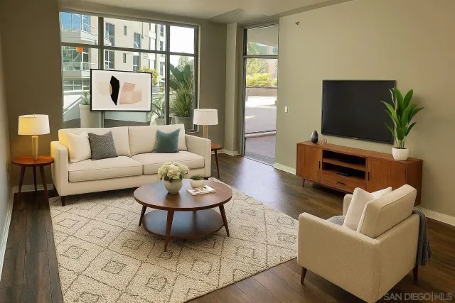 a living room with furniture a flat screen tv and a large window