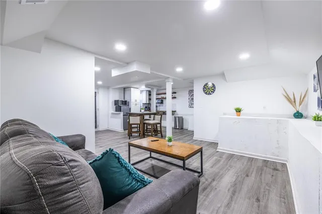 a living room with furniture and wooden floor
