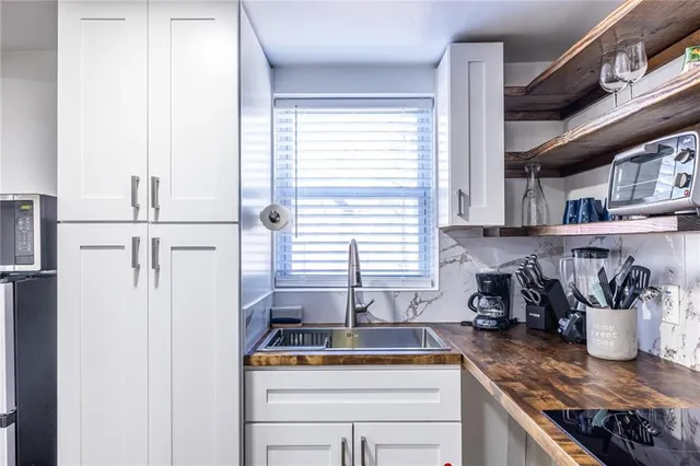 a kitchen with appliances cabinets and a window