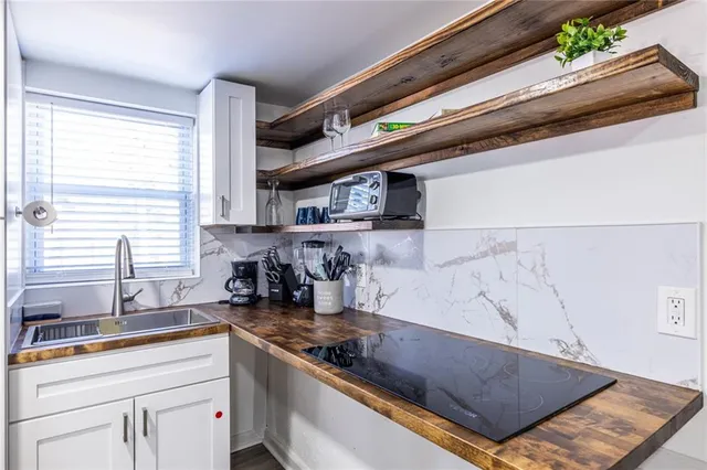 a kitchen with stainless steel appliances granite countertop a sink and a stove