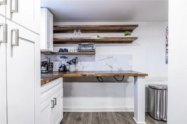 a kitchen with stainless steel appliances granite countertop a sink and cabinets