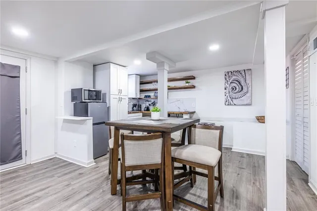 a bathroom with a granite countertop toilet a sink and a mirror