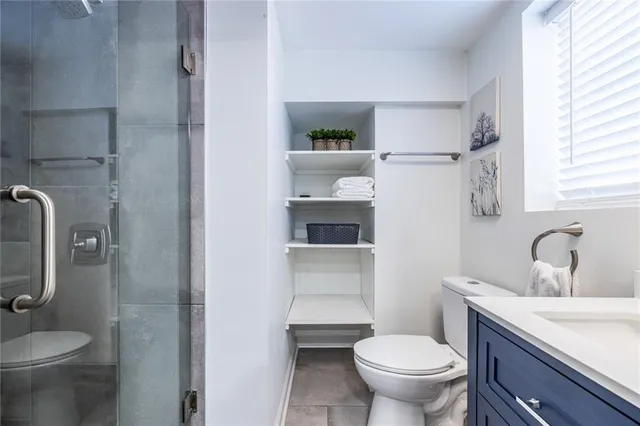 a bathroom with a sink toilet and window