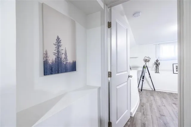 a room with gym equipment and wooden floor