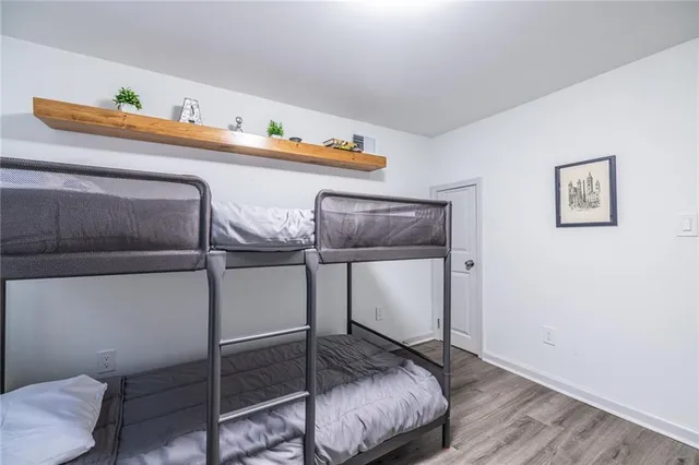 a view of a livingroom with wooden floor and stairs