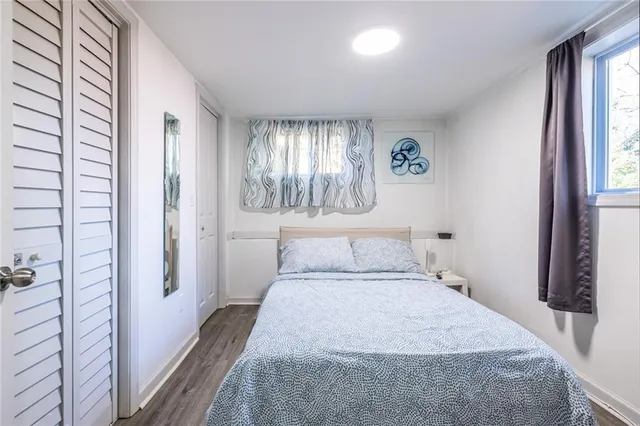 a bedroom with a bed and a window