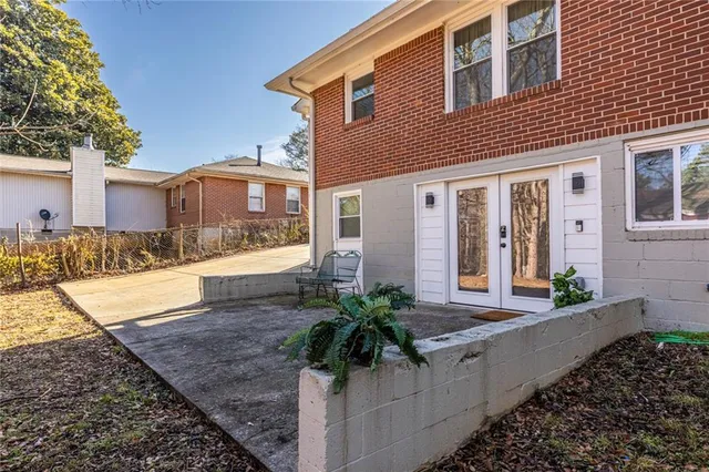 a front view of a house with a yard and potted plants