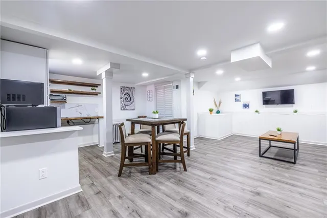 a view of a dining room with furniture and wooden floor