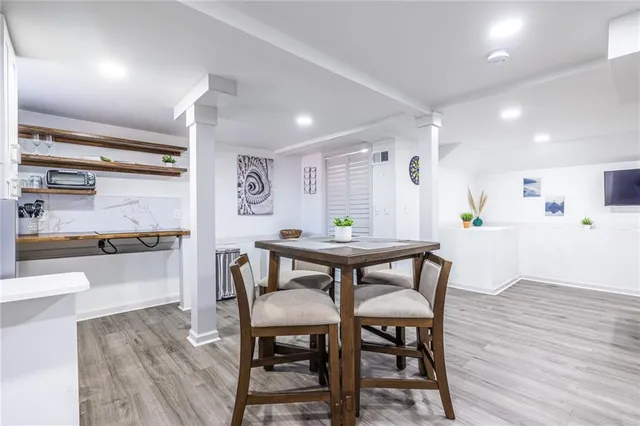 a view of a dining room with furniture and wooden floor