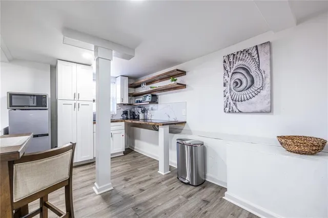 a kitchen with stainless steel appliances granite countertop a refrigerator and a stove top oven